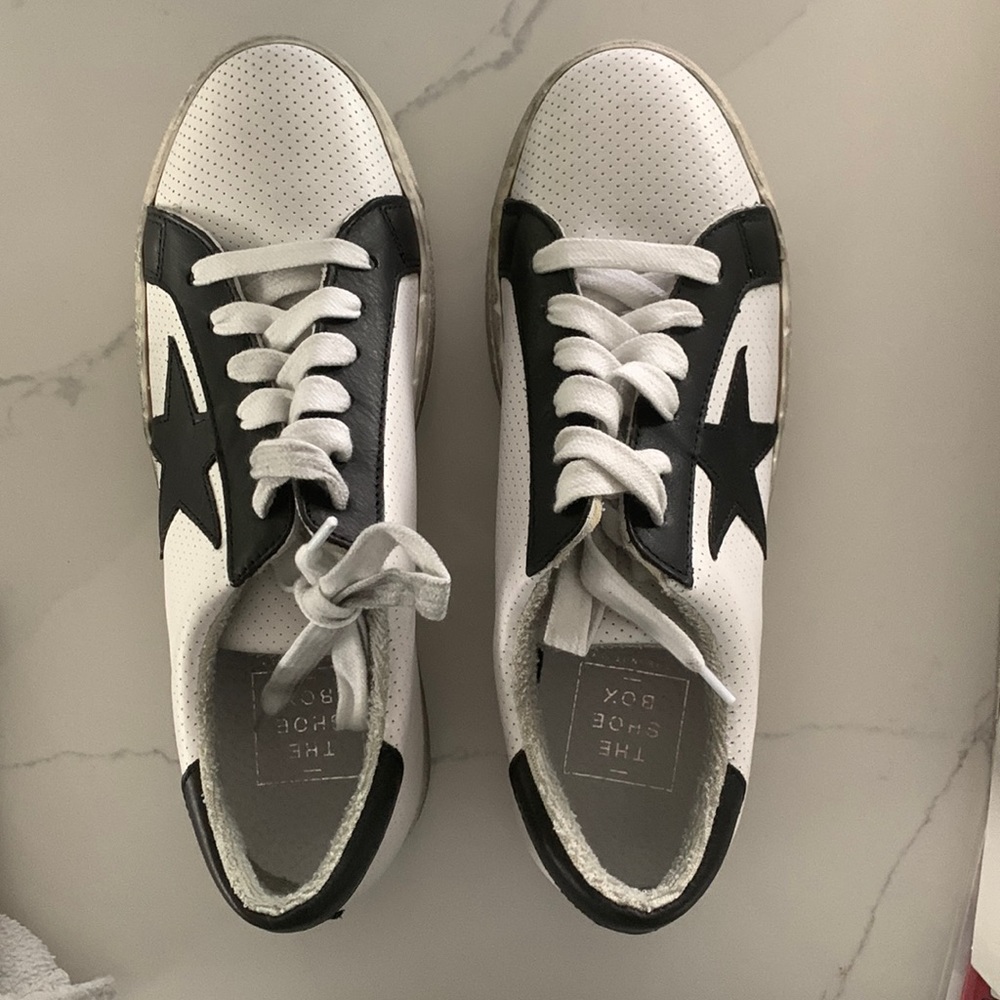 The Shoe box white sneaker with black star on outside of sneaker